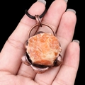 Vintage orange raw stone necklace with antique bronze setting and black cord - Sunstone