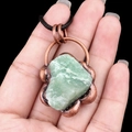 Vintage green raw stone pendant with antique copper base on a black woven cord - Green Aventurine