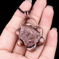 Vintage style necklace featuring a rough reddish-brown gemstone in a floral bronze setting - Strawberry Quartz
