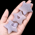 Star-shaped purple crystal druzy stones with natural mineral texture held in palm - Five-pointed Star