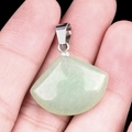 Pale green quartz fan-shaped pendant held in hand showing size and natural texture - 20mm Green Aventurine