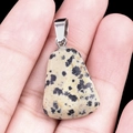 Trapezoid Dalmatian Jasper pendant with silver clip bail held in palm for size reference - Dalmatian Jasper
