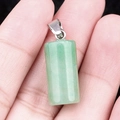 Green crystal cylinder pendant with silver bail shown held by hand for size reference - Green Aventurine