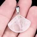 Translucent white fan-shaped crystal pendant with silver metal clasp held in hand - 20mm Clear Quartz