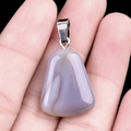 Polished greyish purple agate trapezoid pendant with silver bail shown in hand - Grey Agate