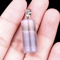 Pale purple crystal cylindrical pendant with silver metal clasp held on hand - Grey Agate