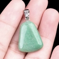 Trapezoid green aventurine stone pendant with silver clasp held in palm for scale - Green Aventurine