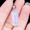 20mm natural opal crystal cylinder pendant with silver bail held in hand - Opal (Synthetic)
