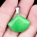 Fan-shaped green crystal gemstone pendant with silver bail shown in hand - 20mm Malaysia Jade (Dyed)