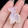 Miniature amethyst deer figurine held in hand showing translucent purple carved detail - Opal (Synthetic)