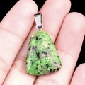 Trapezoid ruby in zoisite crystal pendant with silver clasp on black background - Ruby Zoisite