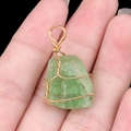 Handmade gold wire-wrapped pendant with light green raw natural gemstone crystal - Fluorite