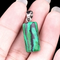 Rectangle green malachite stone pendant with silver metal bail held in hand - Malachite (Synthetic)
