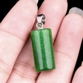 Hand holding green aventurine crystal cylinder pendant with silver bail for necklace - Dyed Malaysian Jade