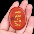 Polished red jasper worry stone engraved with golden 'one day at a time' quote - Red Jasper