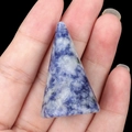 Handheld view of a blue and white sodalite natural stone cone ring holder stand - Sodalite