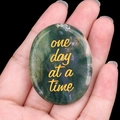 Polished green moss agate stone engraved with golden 'one day at a time' text - India Agate