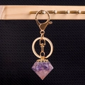 Handmade purple crystal resin diamond keychain with golden metal spiral detail - Amethyst