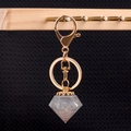 Diamond shaped resin keychain with copper wire spiral and gold crown cap - Labradorite