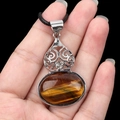 Tiger eye stone oval pendant with ornate silver alloy filigree and black wax cord necklace - Tiger's Eye