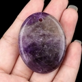 Handheld oval purple amethyst palm stone pendant with natural texture and pre-drilled hole - Amethyst