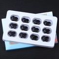 Set of twelve black carved obsidian pig animal figurines in white display tray - Obsidian