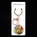 Octagonal resin keychain with colorful crystal stones and gold lobster clasp - Triskelion Octagonal Style (No. 25)