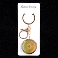 Colorful resin stone flower keychain with golden finish on a white jewelry display card - Radial Spiral Texture Style (No. 27)