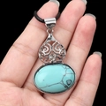 Vintage necklace featuring a large oval turquoise pendant with silver filigree and wax cord - Turquoise (Synthetic)