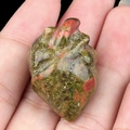 Unakite crystal human heart carving stone held in hand for size reference - Unakite