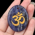 Pendentif ovale en sodalite bleue naturelle avec gravure Om dorée et perçage - Sodalite bleue