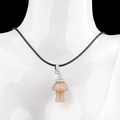 Pink crystal mushroom necklace with silver cap on black cord worn on a white mannequin - Strawberry Quartz