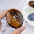 Oval tiger eye palm stone with engraved silver compass star and cardinal directions - Tiger's Eye