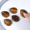 Polished natural tiger eye worry stone with teardrop shape and golden flash finish - Tiger's Eye