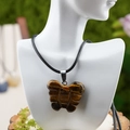Collier avec pendentif papillon en pierre oeil de tigre marron sur cordon noir sur mannequin - Style Oeil de Tigre