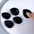 Set of five black teardrop-shaped silicone bra pads with soft flexible texture - Obsidian
