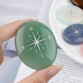 Green aventurine palm stone with engraved silver compass held in hand for size - Green Aventurine