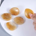 Natural yellow amber crystal thumb stone with teardrop shape for stress relief and massage - Yellow Jade