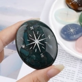 Deep green moss agate palm stone with engraved silver compass design for healing - India Agate