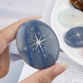 Oval blue natural crystal palm stone with silver engraved compass star pattern - Blue Aventurine