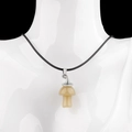 Natural crystal mushroom pendant necklace in beige with a black braided cord - Topaz