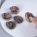Polished Rhodonite worry stone with pink and black veins for stress relief - Rhodonite