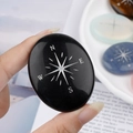 Polished black agate palm stone with silver compass engraving for meditation - Obsidian