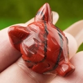 Handcrafted red jasper animal carving with natural black veins in a compact size - Red Jasper