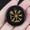 Polished black stone pendant featuring a golden engraved Viking compass symbol with hole - Obsidian