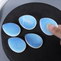 Five droplet-shaped blue opalite palm stones with smooth finish and translucent glow - Opal (Synthetic)