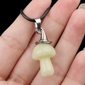 Luminous pale yellow-green agate mushroom necklace with a silver clasp on a black cord - Luminous Stone