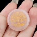 25mm Tree of Life engraved rose quartz crystal stone held by hand for size reference - Rose Quartz