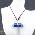 Deep blue lapis lazuli hexagonal crystal point pendant with golden metal clasp and black cord - Lapis Lazuli
