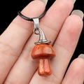 Red jasper mushroom necklace pendant with silver clasp and black cord on hand - Red Jasper